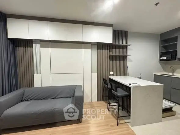 Modern studio apartment with sleek kitchen and cozy living area
