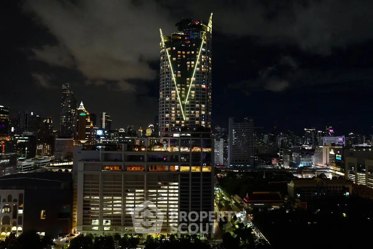 Stunning night view of a modern cityscape with illuminated skyscrapers.