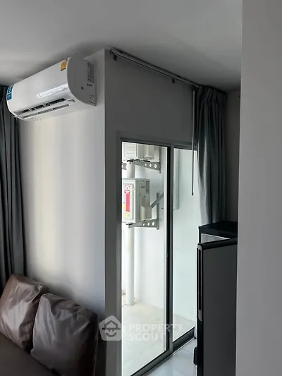 Modern apartment with air conditioning and sliding glass door to balcony