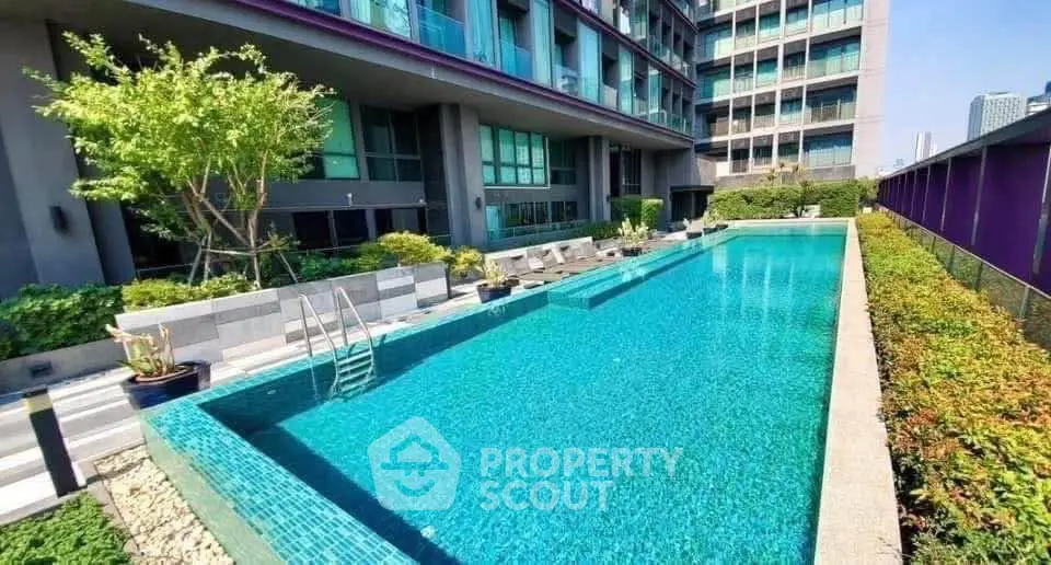 Luxurious condominium with a stunning outdoor pool and lush greenery, perfect for relaxation and leisure.