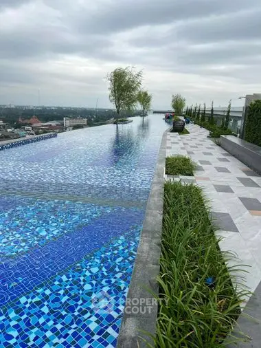 Luxurious rooftop infinity pool with panoramic city views, offering a serene escape and perfect for upscale urban living.