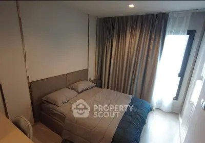 Cozy bedroom with modern decor and large window for natural light