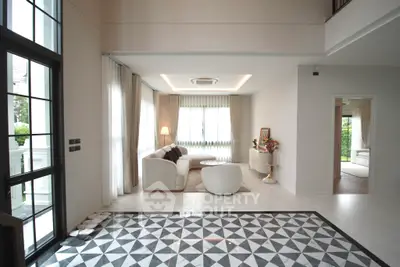 Elegant living room with modern decor and large windows for natural light