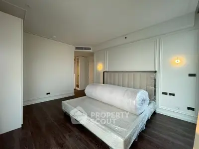 Spacious bedroom with modern bed frame and elegant lighting