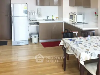 Modern kitchen with dining area, featuring sleek cabinets and appliances, perfect for contemporary living.