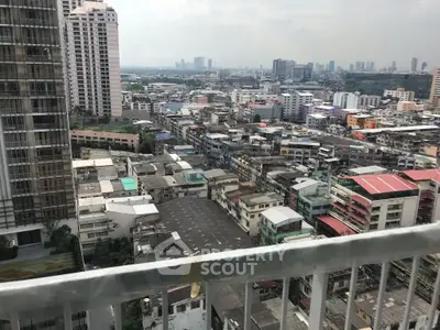 Stunning urban cityscape view from a high-rise balcony, showcasing diverse architecture and skyline.