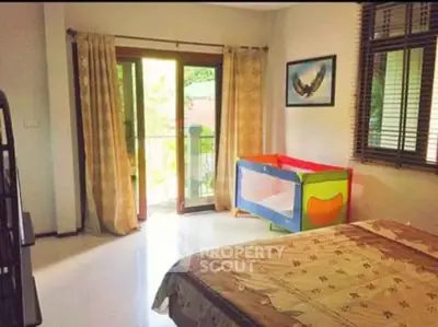 Spacious bedroom with balcony access and natural light, ideal for family living.