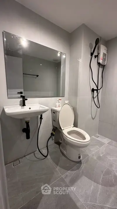 Modern bathroom with sleek fixtures and spacious shower area