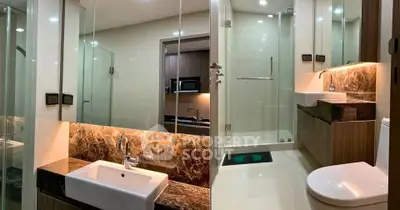 Modern bathroom with glass shower and elegant marble sink countertop
