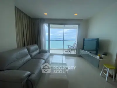 Spacious living room with ocean view and modern furnishings in a luxury apartment.