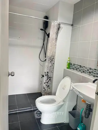 Modern bathroom with sleek shower and stylish tiles in contemporary home.