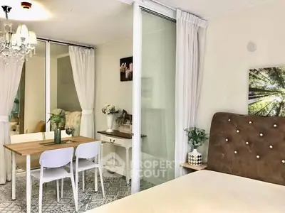 Charming bedroom with elegant decor and dining area, featuring a cozy ambiance and stylish furnishings.