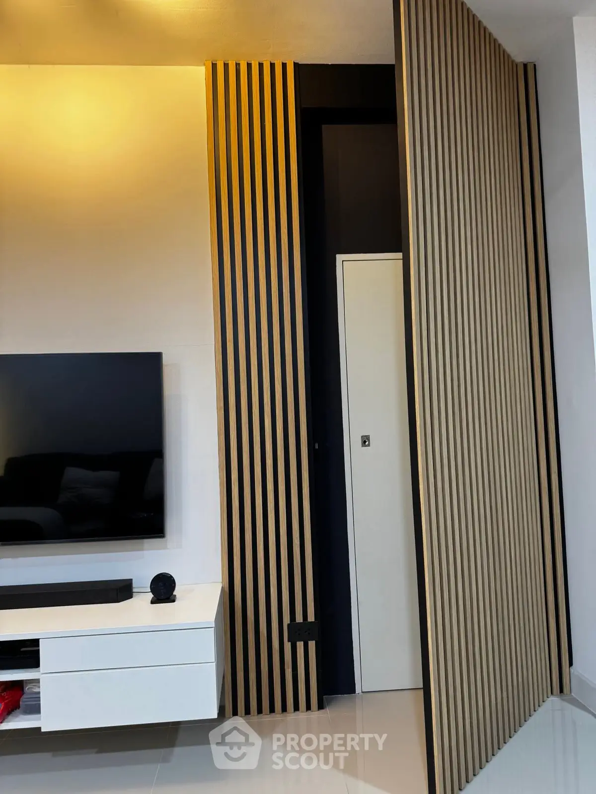 Modern living room with sleek TV unit and stylish wooden paneling