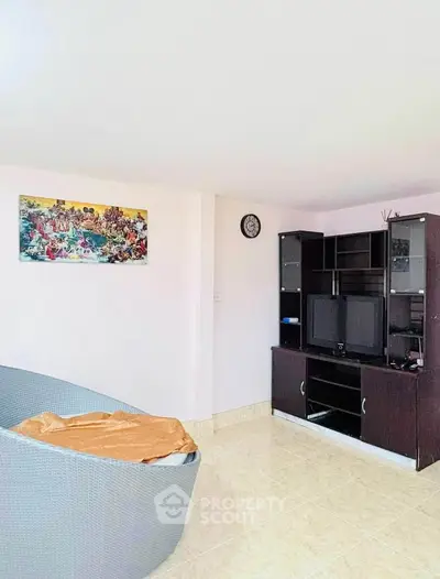 Spacious living room with modern entertainment center and cozy seating area.