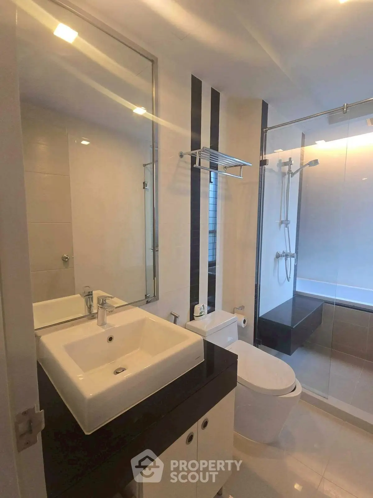 Modern bathroom with sleek fixtures and glass shower enclosure