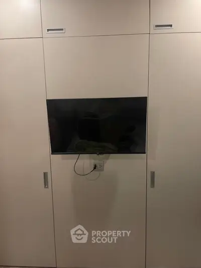 Modern built-in storage unit with sleek design and integrated TV space
