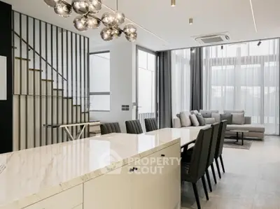 Luxurious open-plan living room with modern decor and elegant lighting