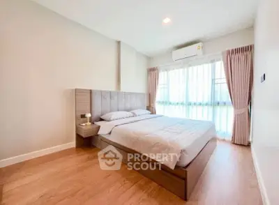 Spacious bedroom with modern design and natural light in a stylish apartment.