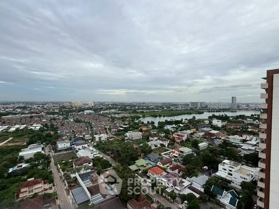 Stunning aerial view of urban landscape with residential buildings and scenic lake.