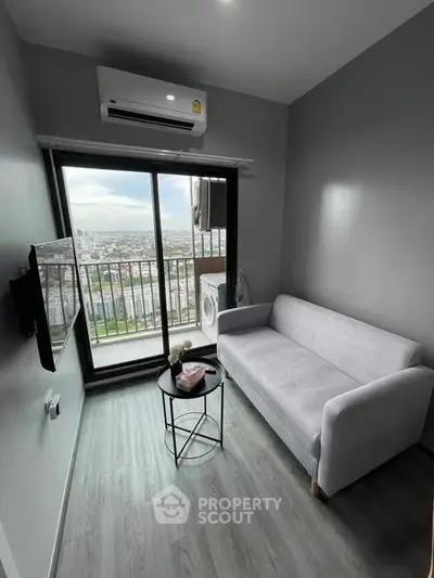 Modern living room with balcony view in high-rise apartment