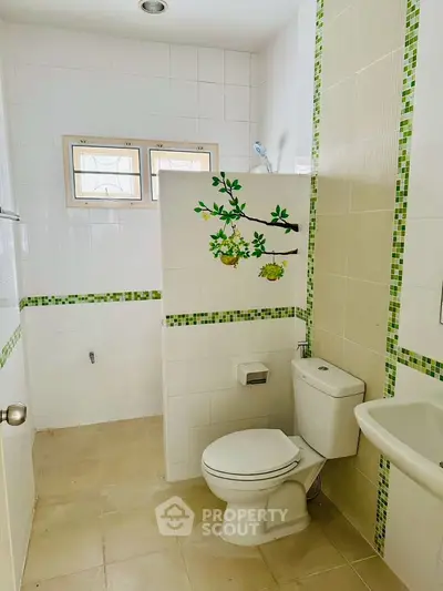 Bright and modern bathroom with decorative tiles and natural light.