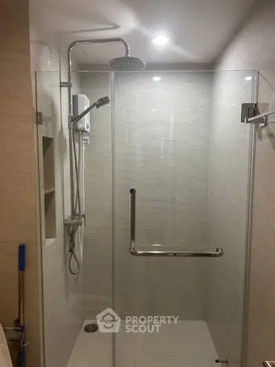 Modern bathroom with glass shower enclosure and sleek fixtures