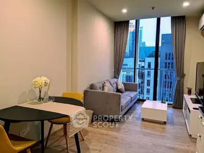 Modern living room with city view, stylish furniture, and natural light.
