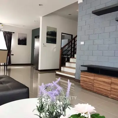 Modern living room with stylish decor and staircase in contemporary home