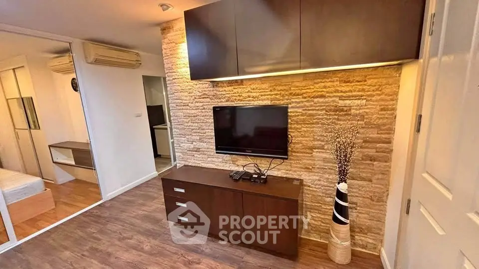 Modern living room with stone accent wall and sleek TV setup