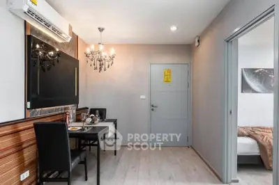 Modern dining area with elegant chandelier and cozy bedroom view