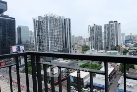 Stunning cityscape view from a high-rise balcony overlooking modern skyscrapers and urban landscape.