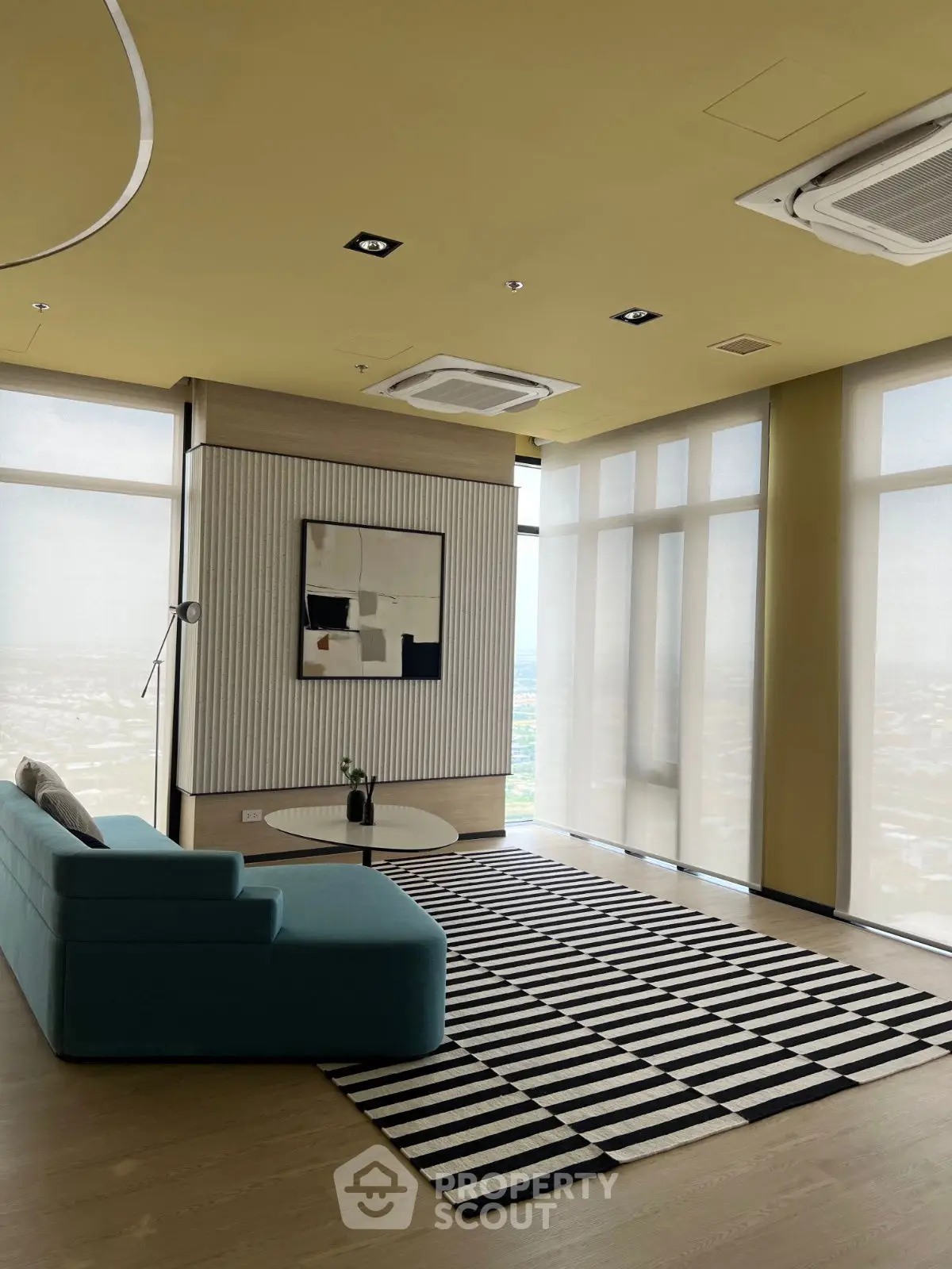 Modern living room with stylish decor and panoramic city views.
