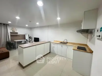 Modern open-layout kitchen with sleek cabinetry and spacious living area