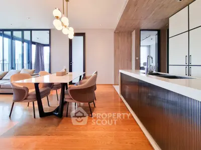 Luxurious open-plan living and dining area with modern kitchen and elegant lighting.