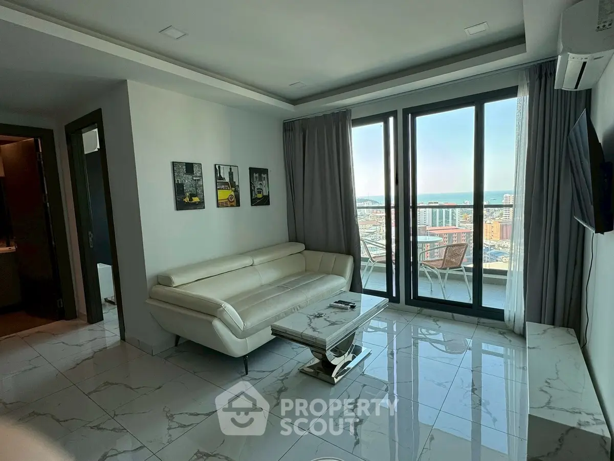 Modern living room with stunning city view and elegant white leather sofa.