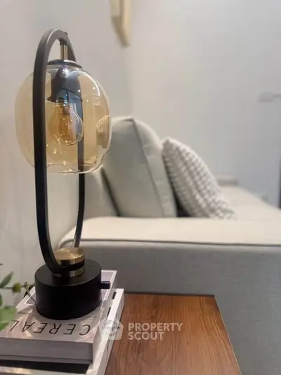 Modern living room with stylish lamp and cozy sofa, perfect for relaxation.