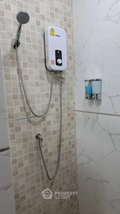 Modern bathroom with shower and water heater, featuring stylish tile design.