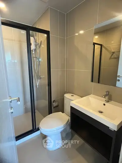 Modern bathroom with sleek shower and contemporary fixtures in stylish apartment.