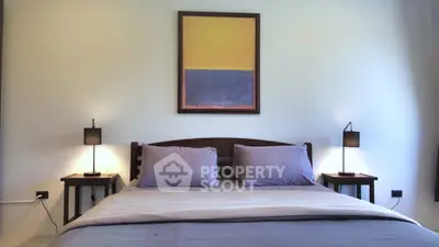 Elegant bedroom with modern decor and cozy lighting, perfect for relaxation and comfort.