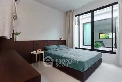 Modern bedroom with large window and minimalist decor