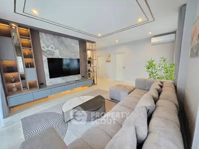 Luxurious modern living room with plush sectional sofa and large TV