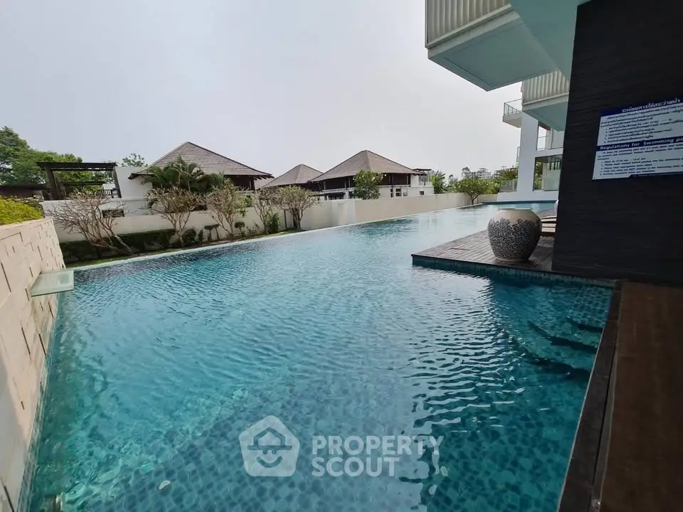 Luxurious outdoor pool area with serene surroundings and modern architecture.