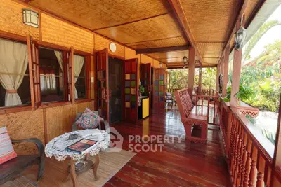 Charming wooden balcony with cozy seating and lush garden view, perfect for relaxation and outdoor enjoyment.