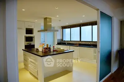 Modern kitchen with island and sleek design in a spacious apartment