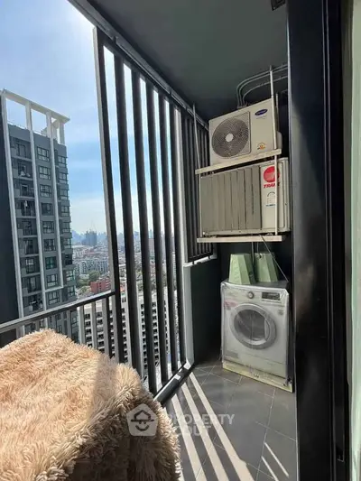 Modern balcony with city view, featuring laundry appliances and sleek railing design.