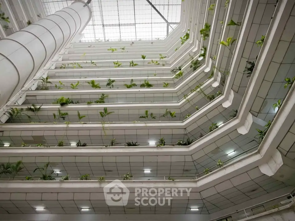 Stunning multi-level atrium with modern architecture and lush greenery