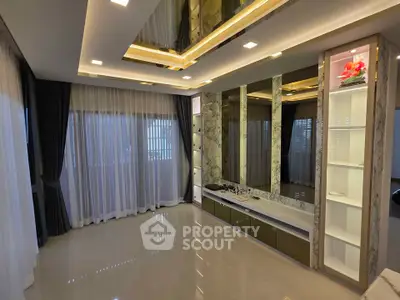 Luxurious modern living room with elegant ceiling design and floor-to-ceiling windows.