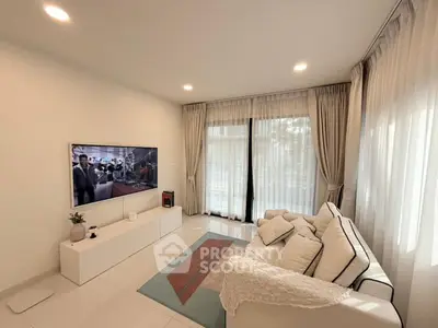 Modern living room with large windows and cozy seating area