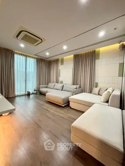 Spacious modern living room with elegant decor and ample natural light