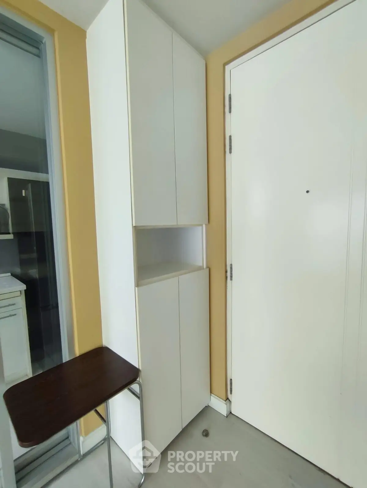 Modern entryway with sleek white cabinets and a minimalist design